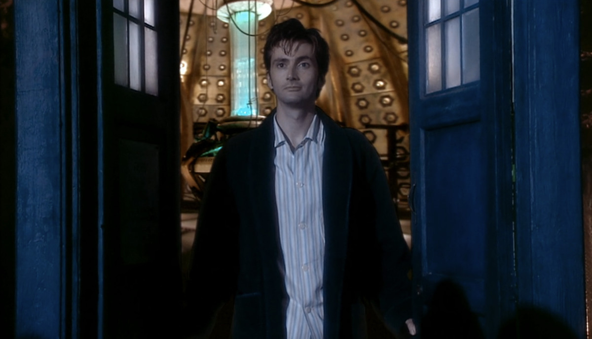 The Tenth Doctor (David Tennant) opening the doors to the TARDIS and smiling a bit.