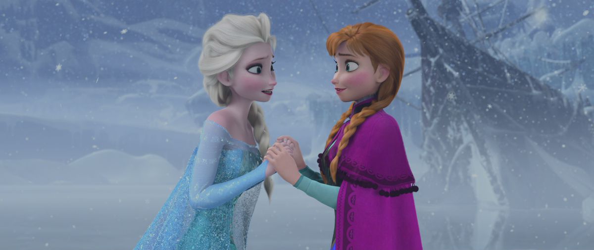 Anna and Elsa holding hands at the end of Frozen, after Anna’s act of true love saves the day