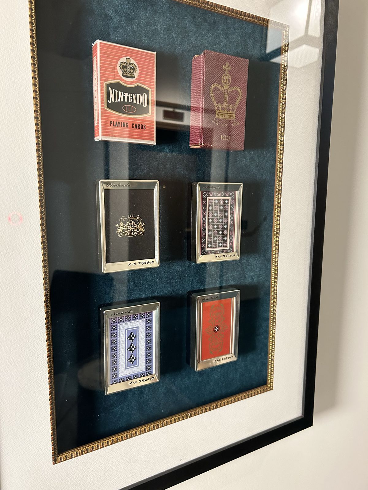 A collection of vintage playing cards from Nintendo’s days as a card company, displayed under glass at the Marufukuro in Kyoto
