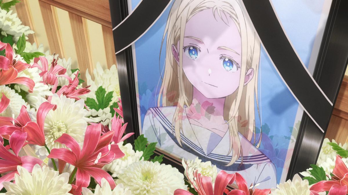 A close-up shot of a blonde-haired, blue-eyed girl’s funeral portrait surrounded by flowers.