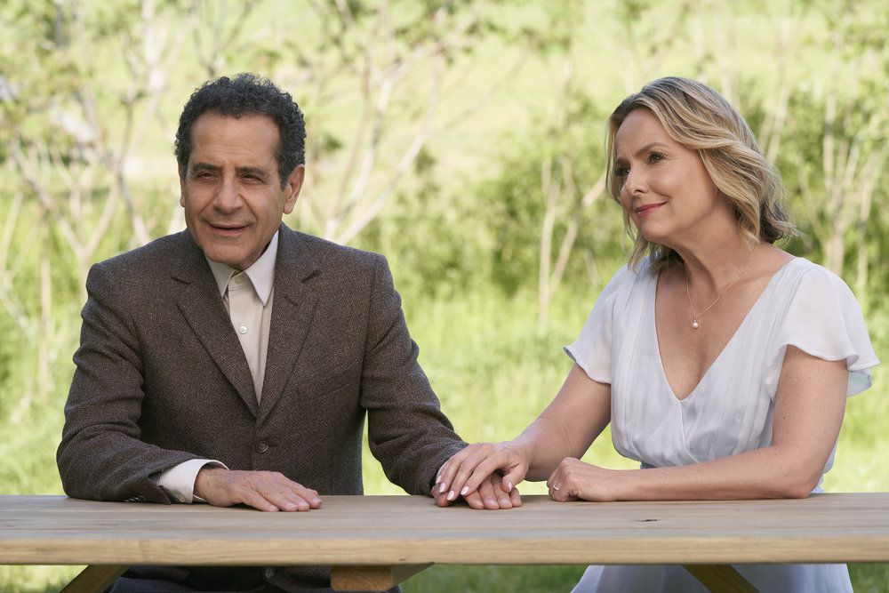 Monk (Tony Shalhoub) sitting and holding hands with the ghost of his wife Trudy (Melora Hardin) 