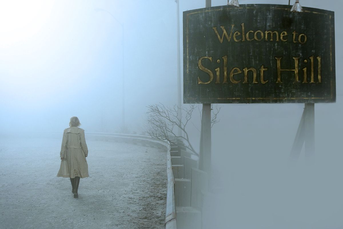 A still from the movie Silent Hill showing the “Welcome to...” sign shrouded in fog