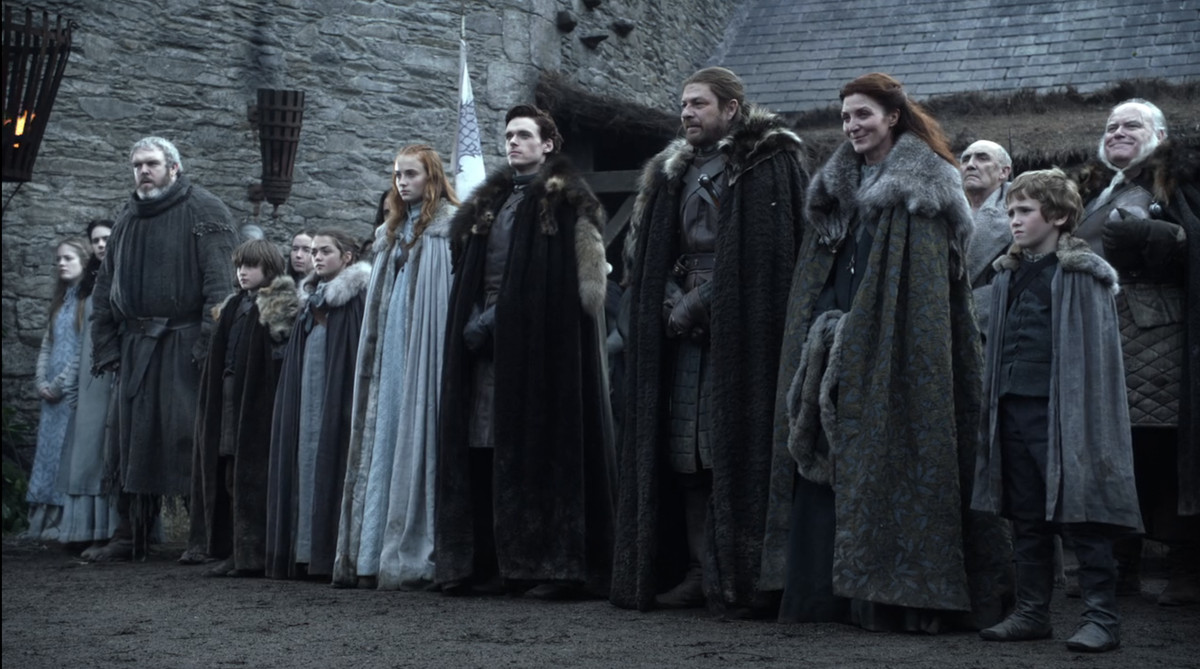 The Stark family lined up and waiting for the king in the pilot of Game of Thrones