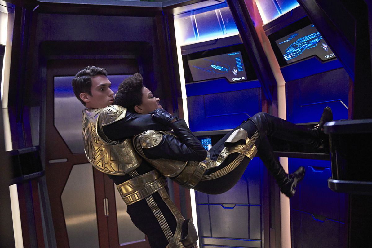 Sonequa Martin-Green as Burnham, midflip as she tries to escape from someone’s hold