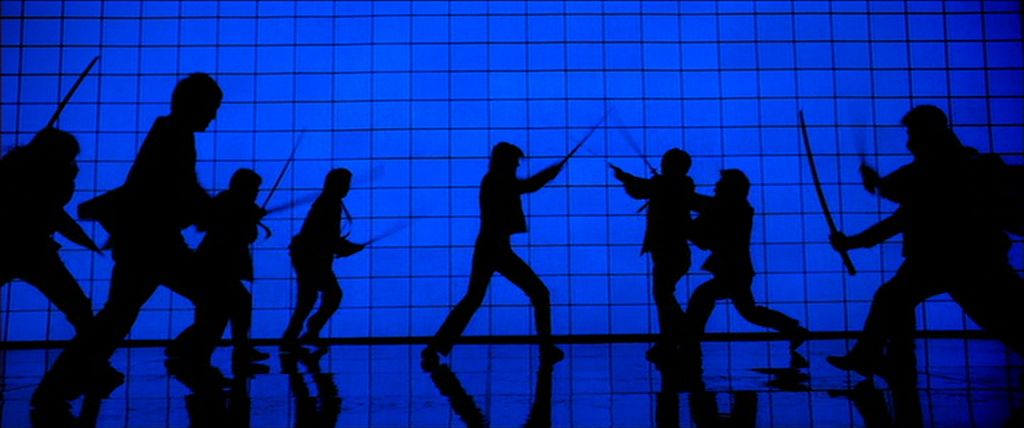 The silhouette of a woman clashing swords against a room of opponents in front of a blue backlit wall in Kill Bill Vol. 1.