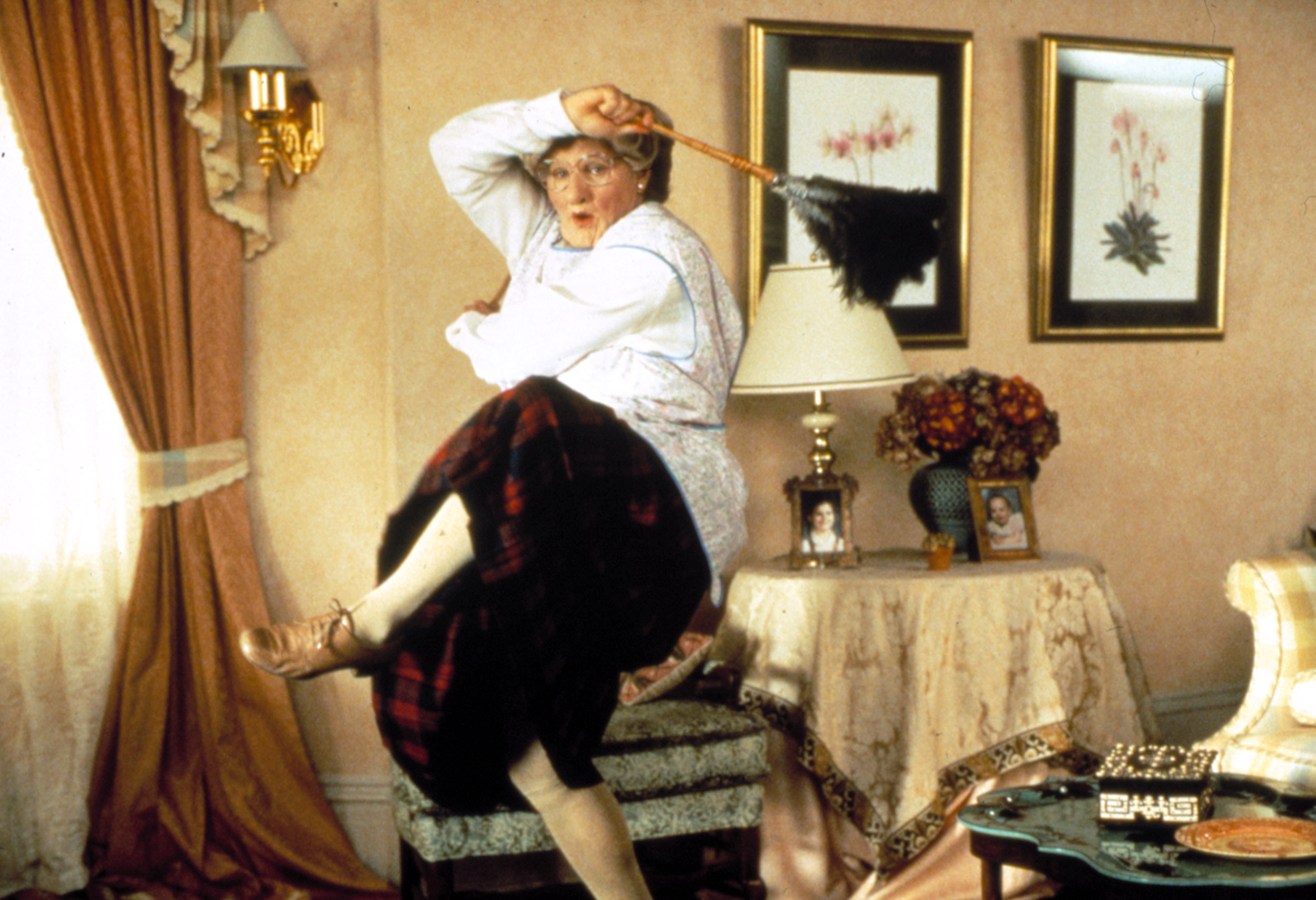 Robin Williams dressed as an old woman, dancing while cleaning the house in Mrs. Doubtfire