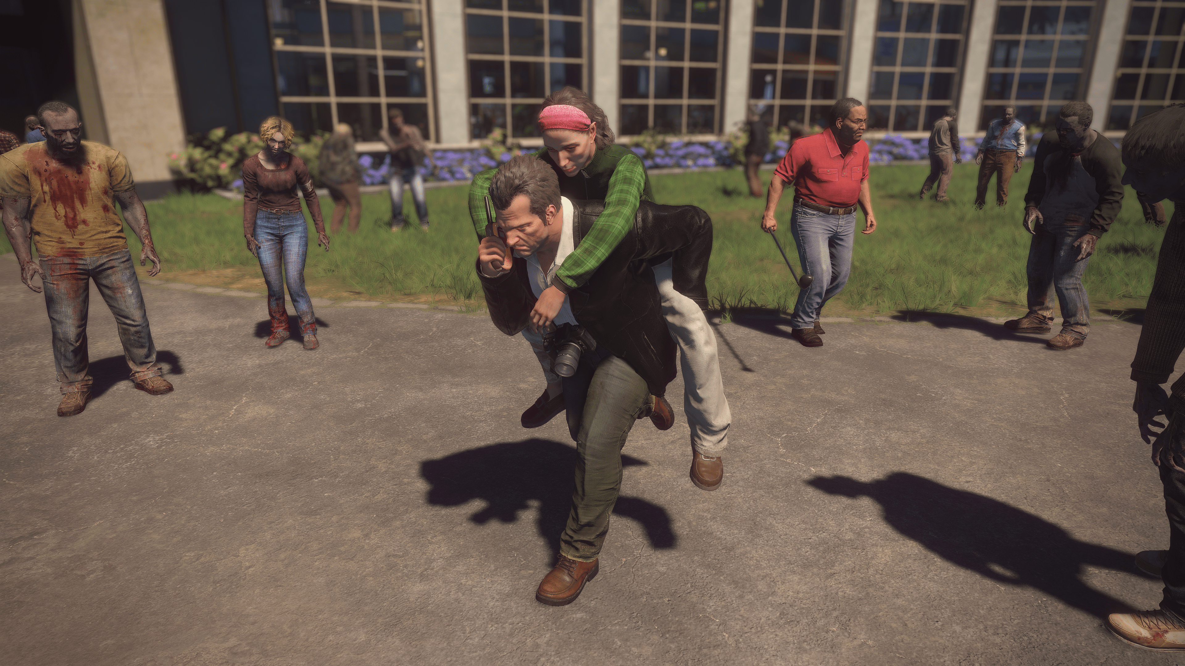 Frank West carries a female survivor on his back through a crowd of zombies in a screenshot from Dead Rising Deluxe Remaster