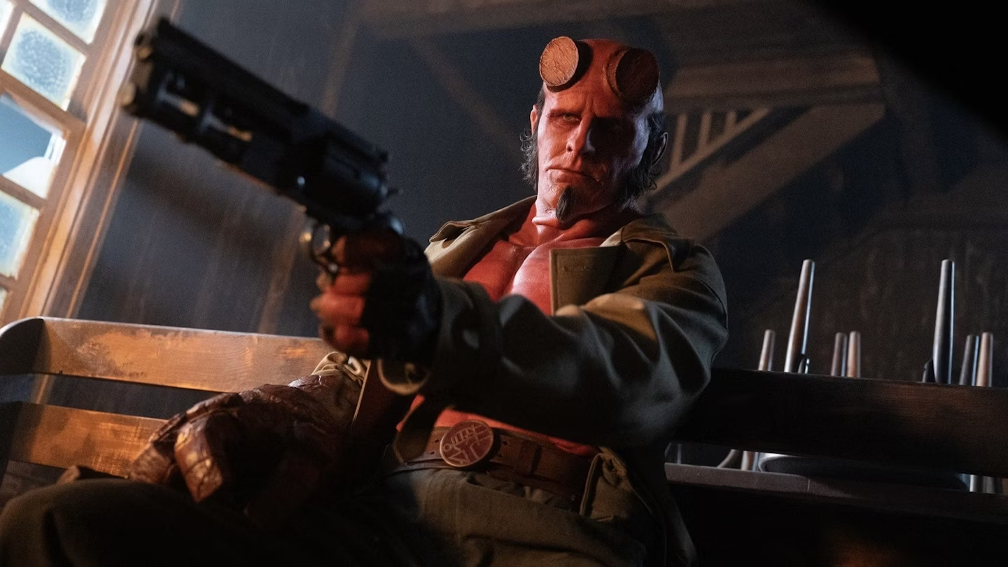 Hellboy (Jack Kesy) pointing a pistol in Hellboy: The Crooked Man.