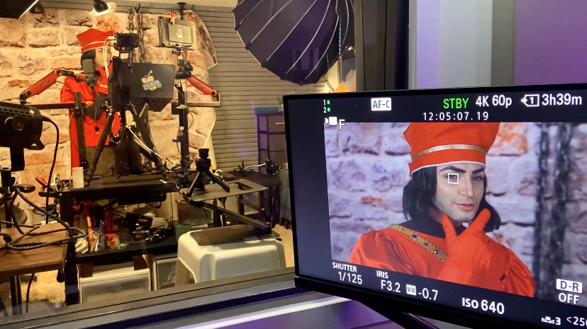 Gibi ASMR dressed as Farquad appears on a film monitor.