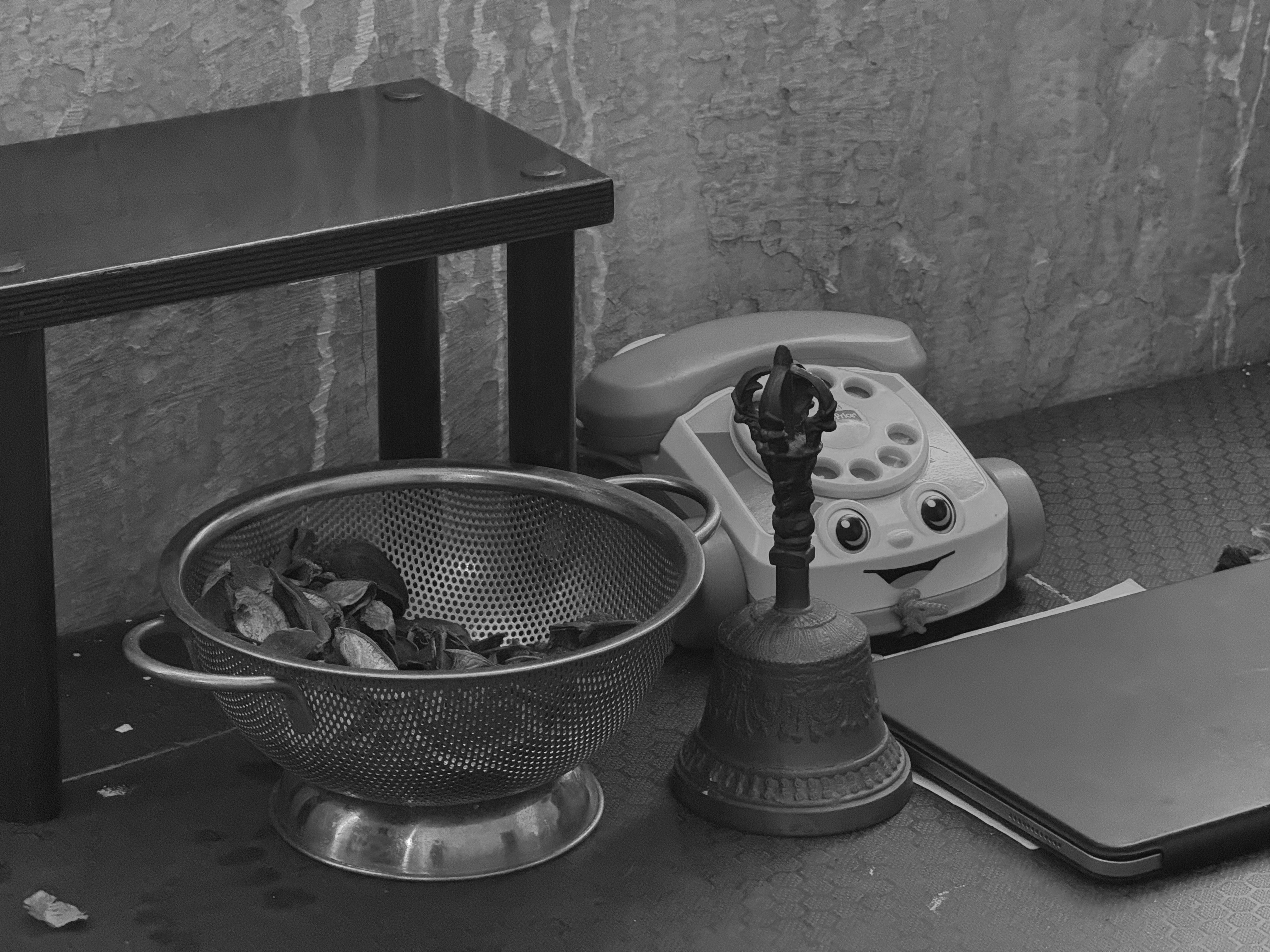 A toy phone, a bell, and an iPad from the October 3, 2024 performance of Curios in the Catacombs by Margaret Leng Tan at Green-Wood Cemetery in New York