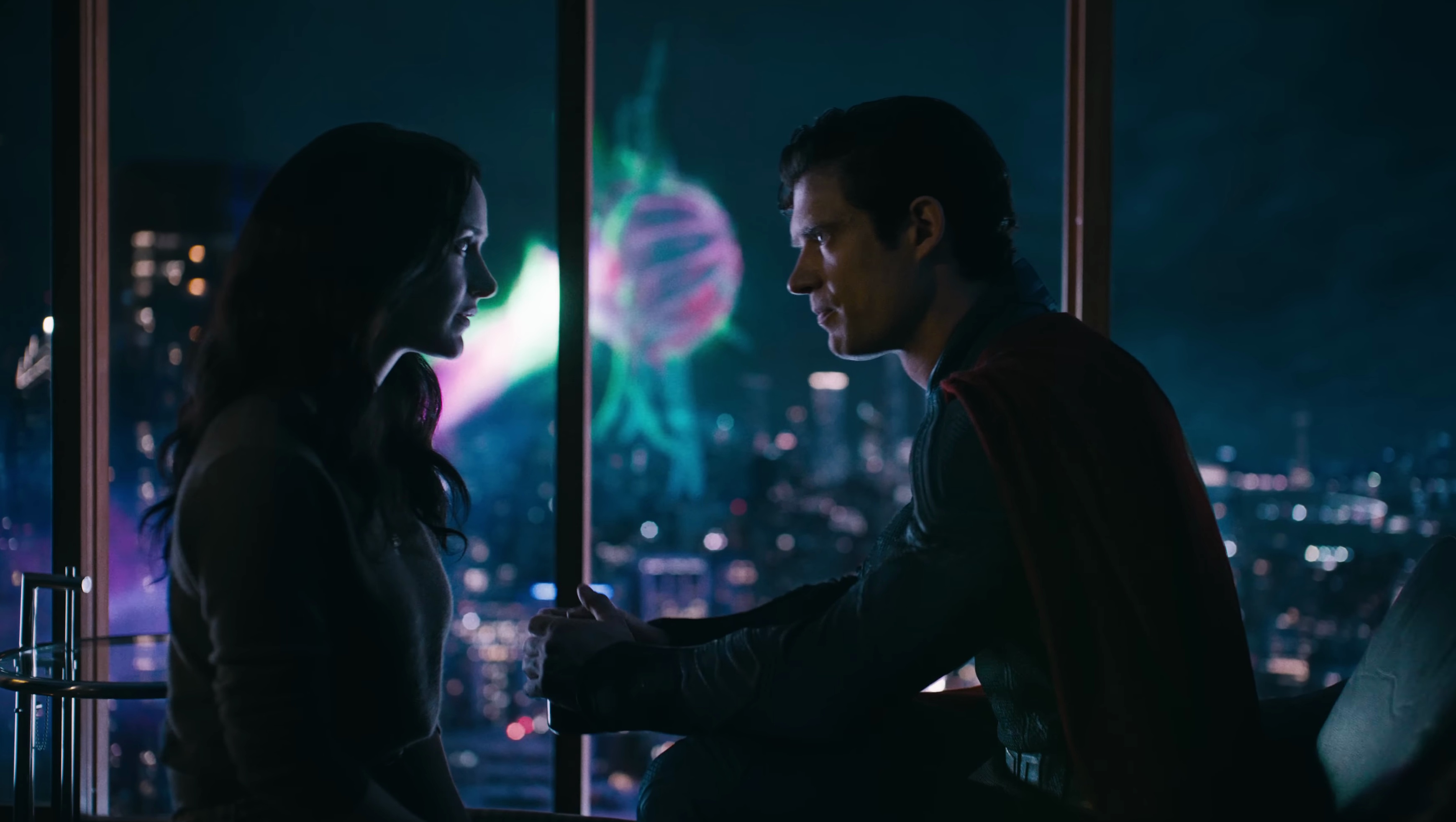 Lois and Superman 2025 chat in front of an alien eyeball attacking the city