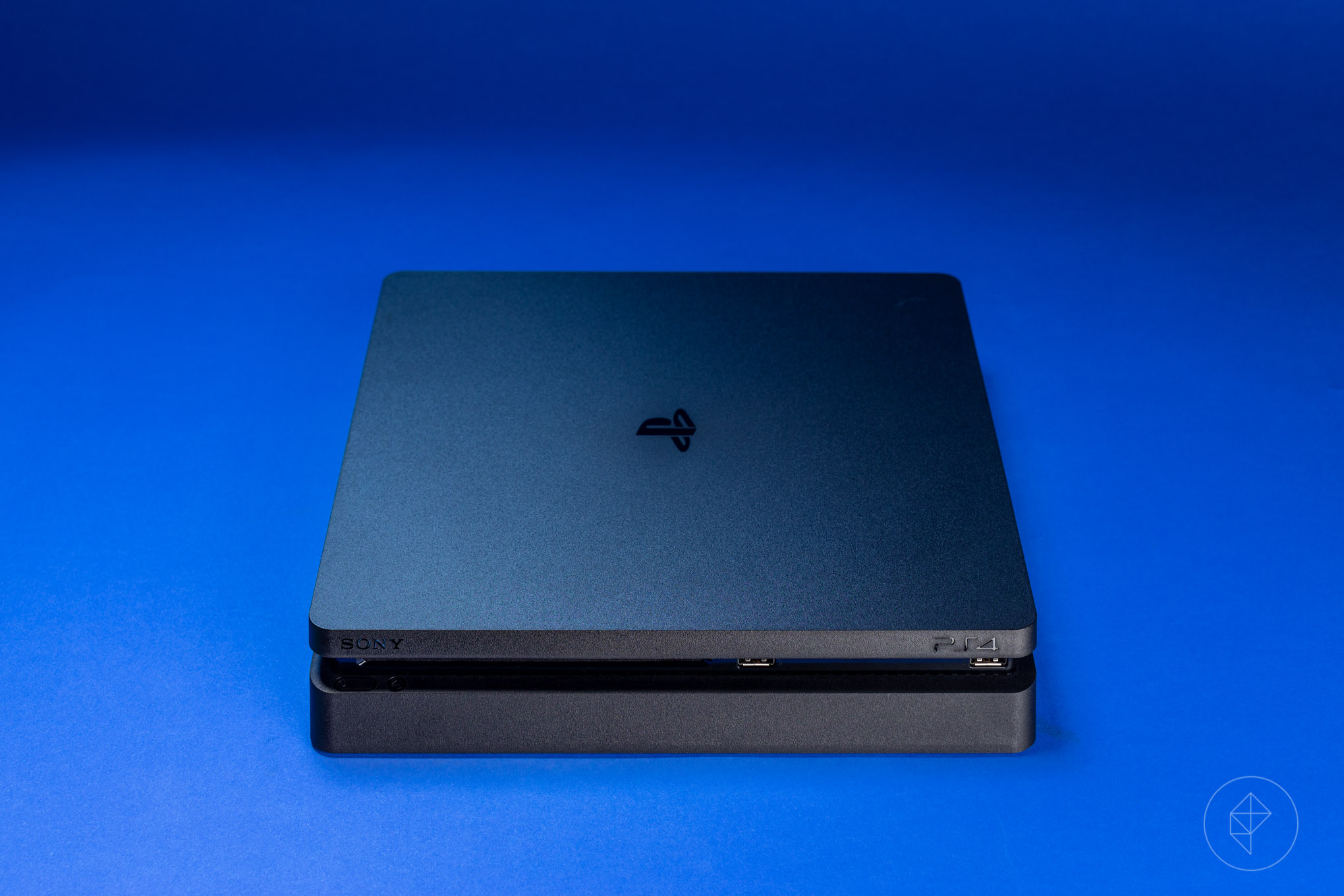 PS4 Slim console on blue background