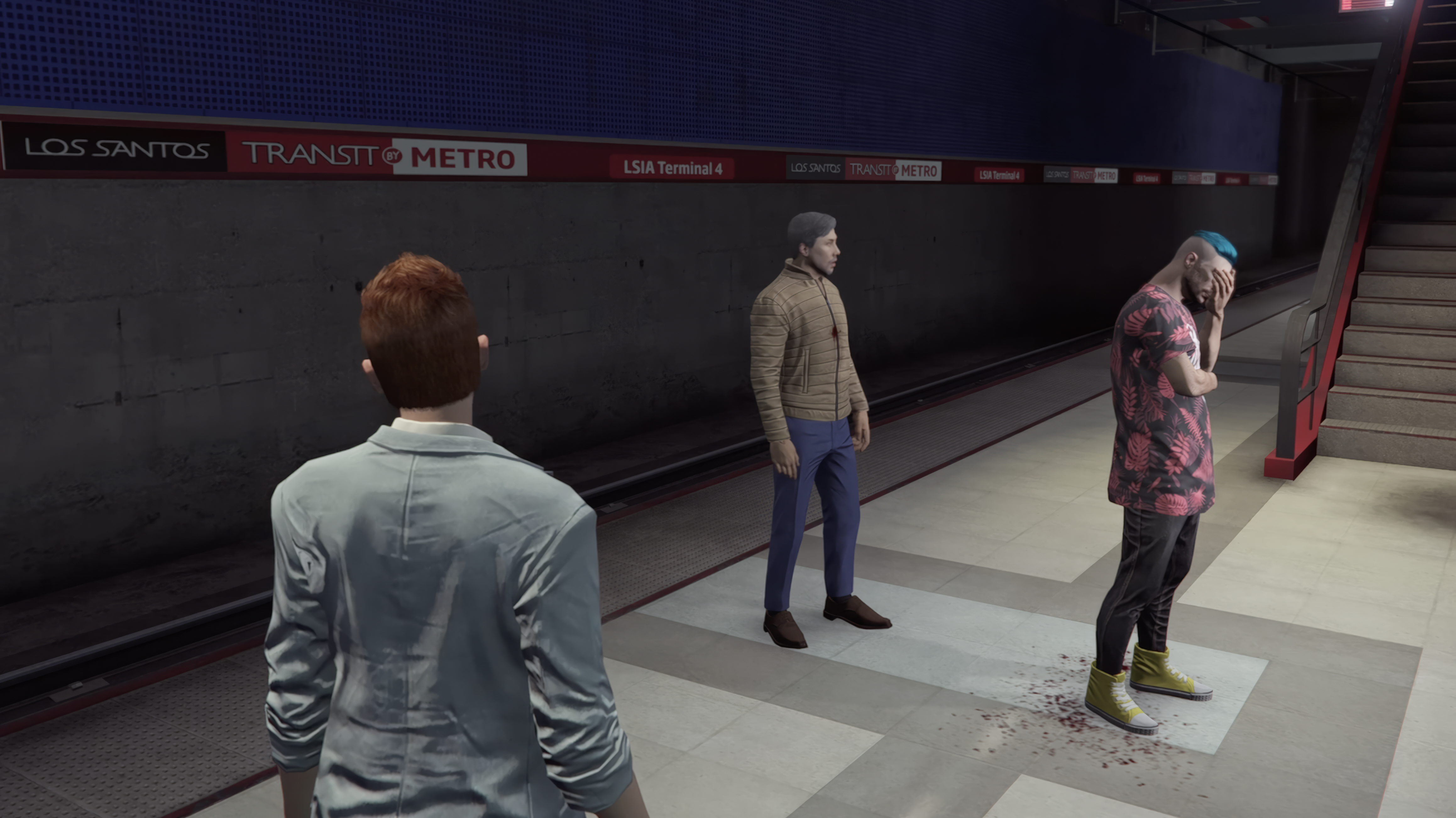 Three GTAO characters stand in a subway station in Grand Theft Hamlet. One has his head in his hands