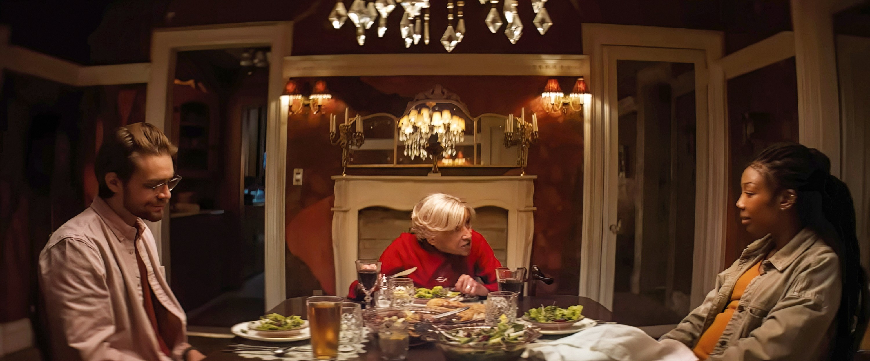 Norman (Andrew Burnap) and Belinda (Brandy Norwood), a middle-class, mixed-race couple, sit on either side of a dinner table, flanking Norman’s elderly mother Solange (Kathryn Hunter) in Sam and Max Eggers’ A24 horror movie The Front Room