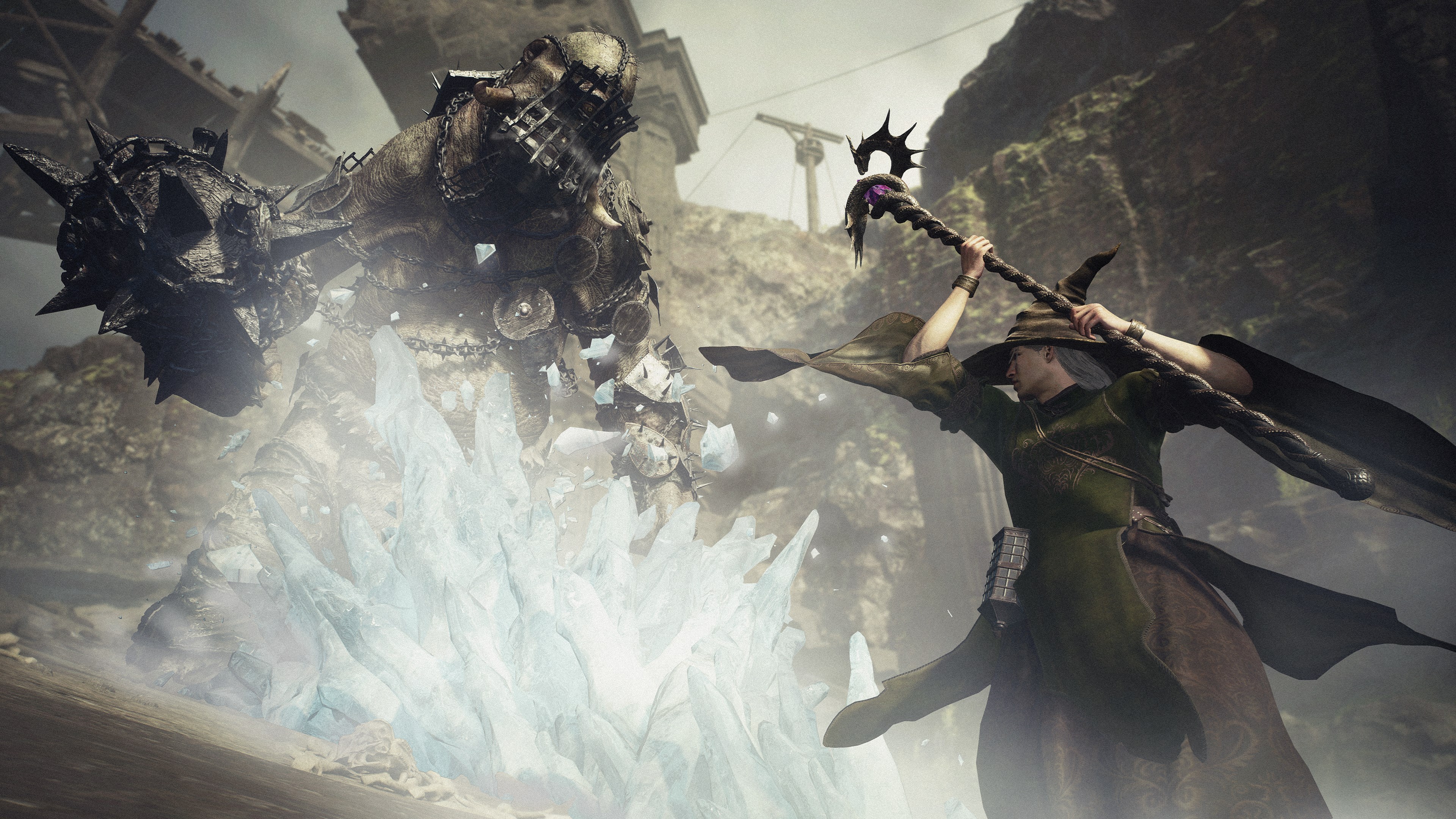 A warfarer using a staff casts an ice spell on a giant armored monster in a screenshot from Dragon’s Dogma 2