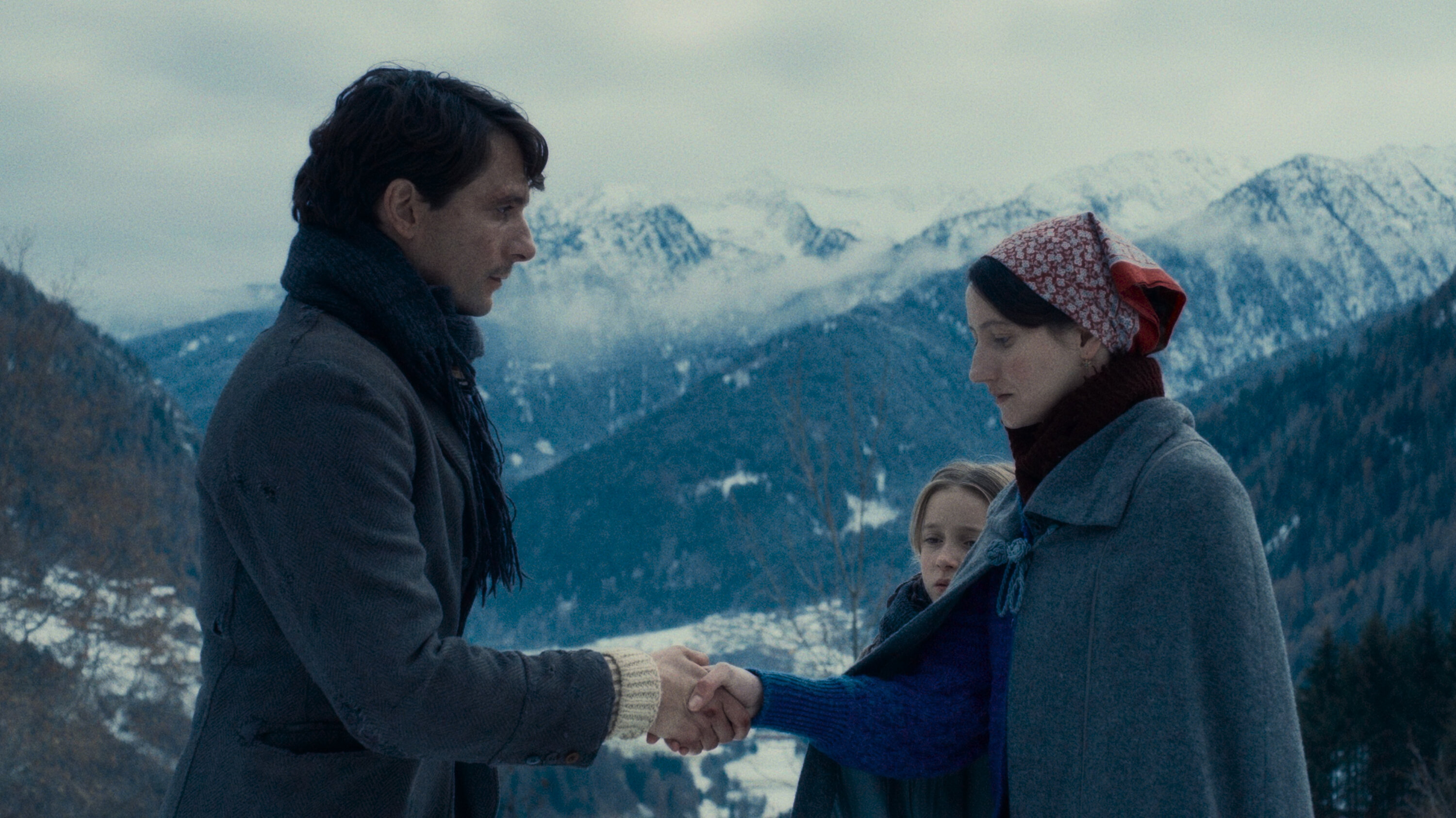 A man and a woman shaking hands in Vermiglio.