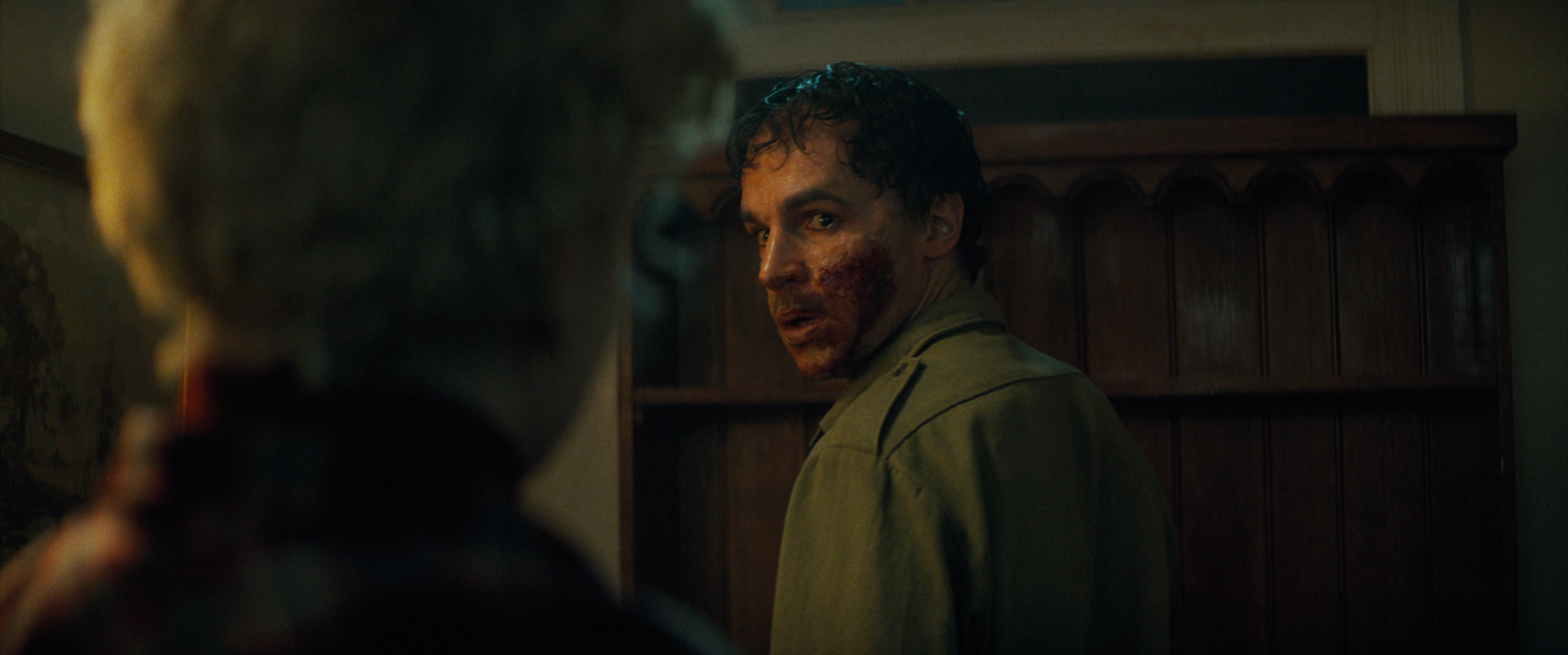 Christopher Abbott as Blake, a man with blood on his mouth, in Wolf Man. 