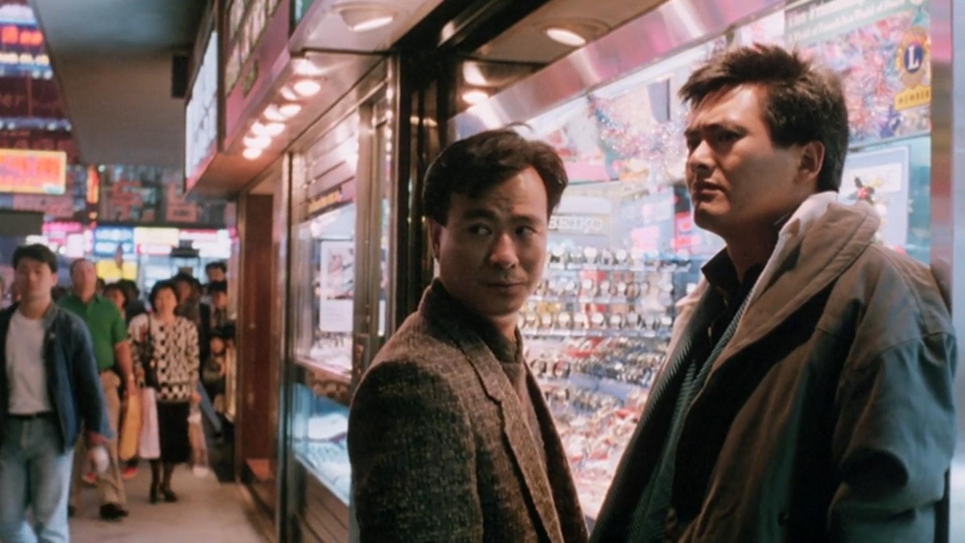 Chow Yun-fat and Danny Lee lean against a glass display case in City on Fire