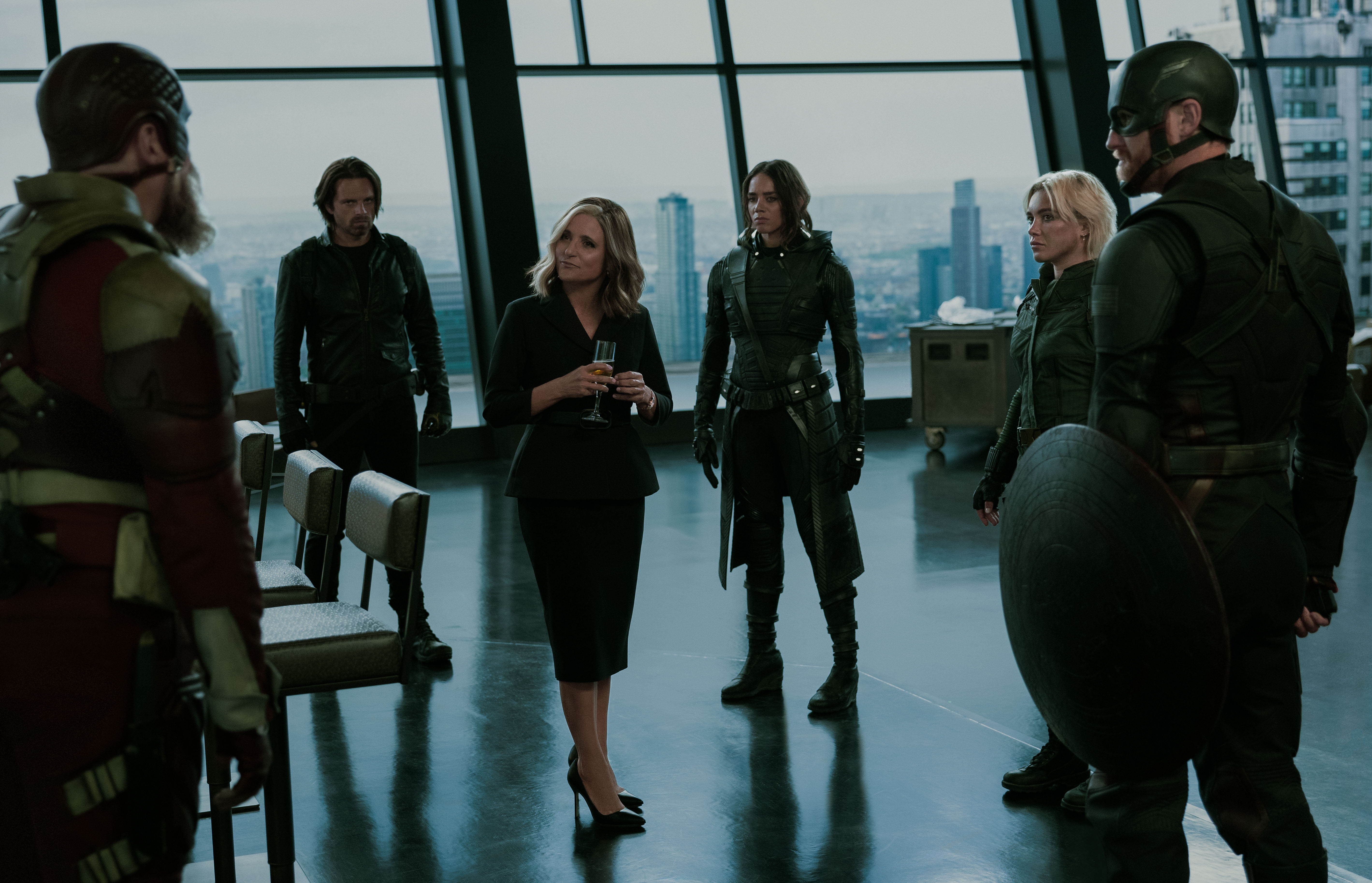 Allegra de Fontaine (Julia Louis-Dreyfus) stands amid the Thunderbolts in Tony Stark’s penthouse in Avengers Tower in Thunderbolts*