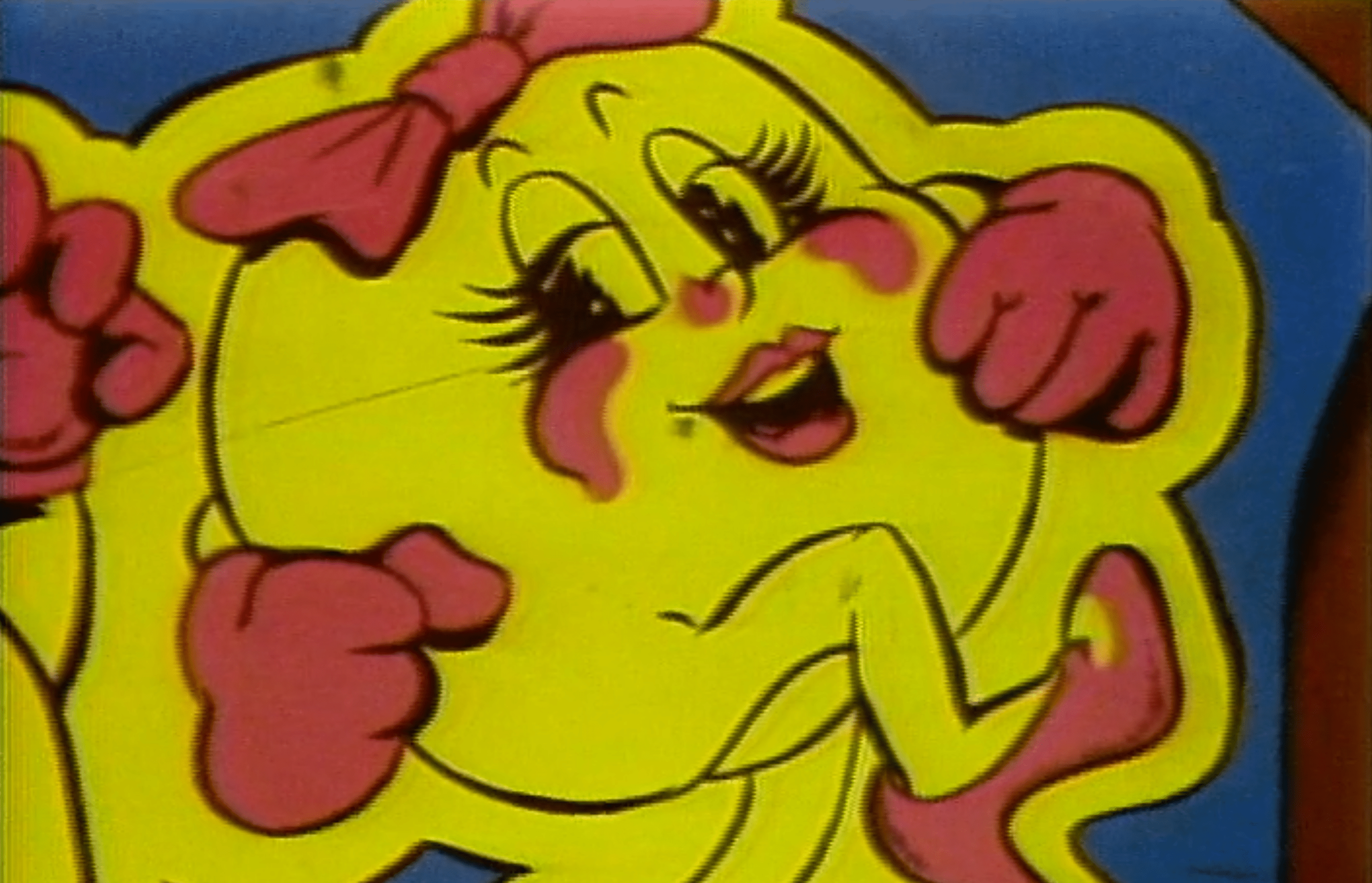 A close-up of Ms. Pac-Man on the side of a vintage arcade machine.