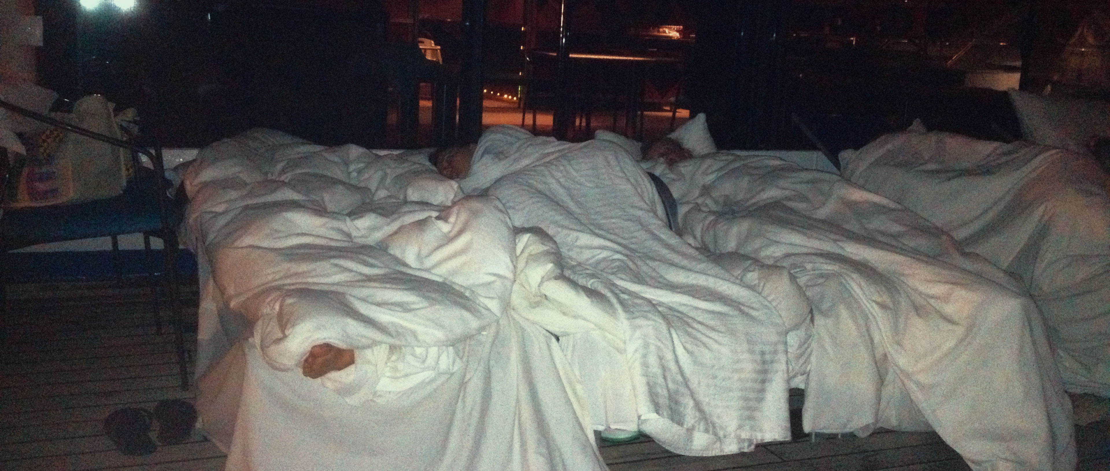 People sleeping in the lobby of a cruise ship in Poop Cruise