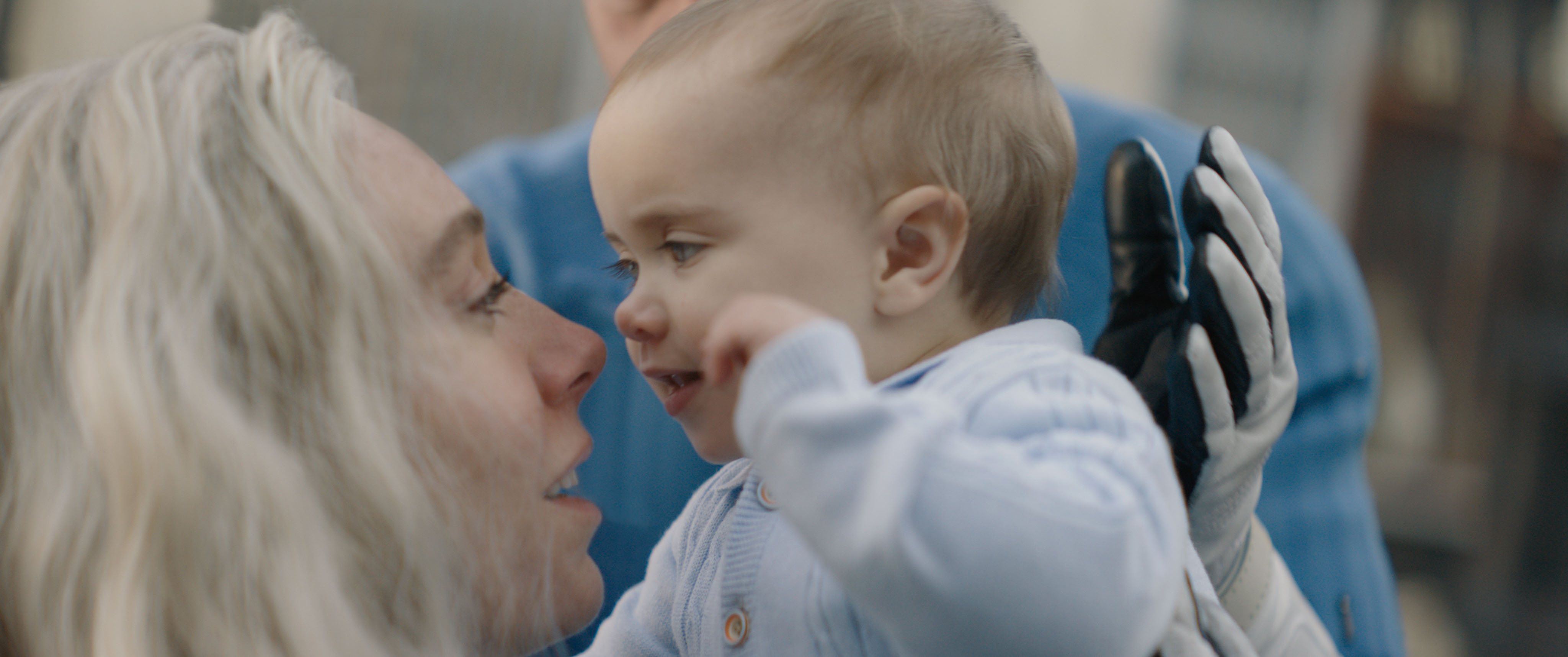 Vanessa Kirby as Sue Storm/Invisible Woman holds up her baby Franklin in Fantastic Four: First Steps