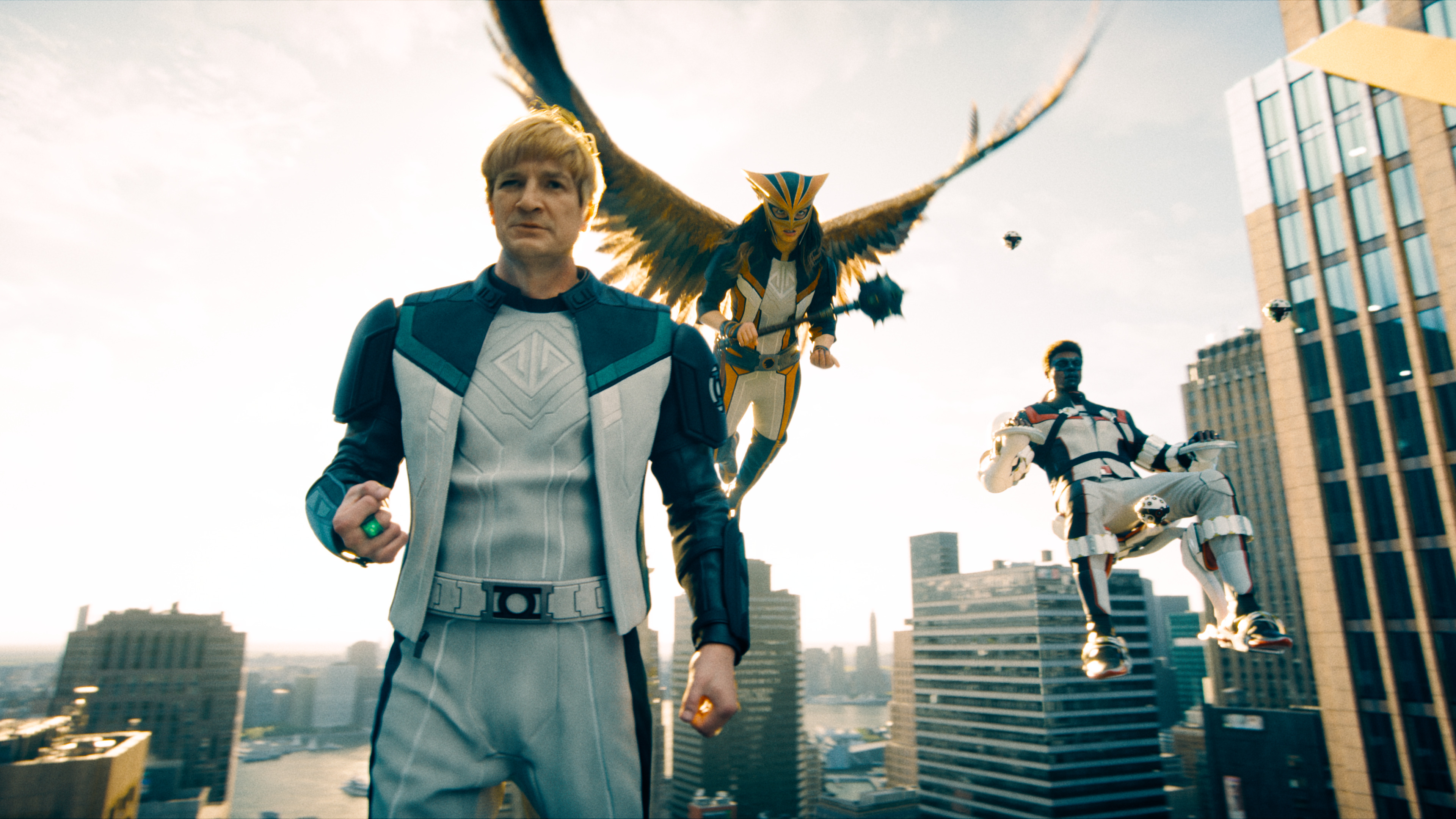 Guy Gardner (Nathan Fillion), Hawkgirl (Isabela Merced), and Mr. Terrific (Edi Gathegi) fly above Metropolis in Superman